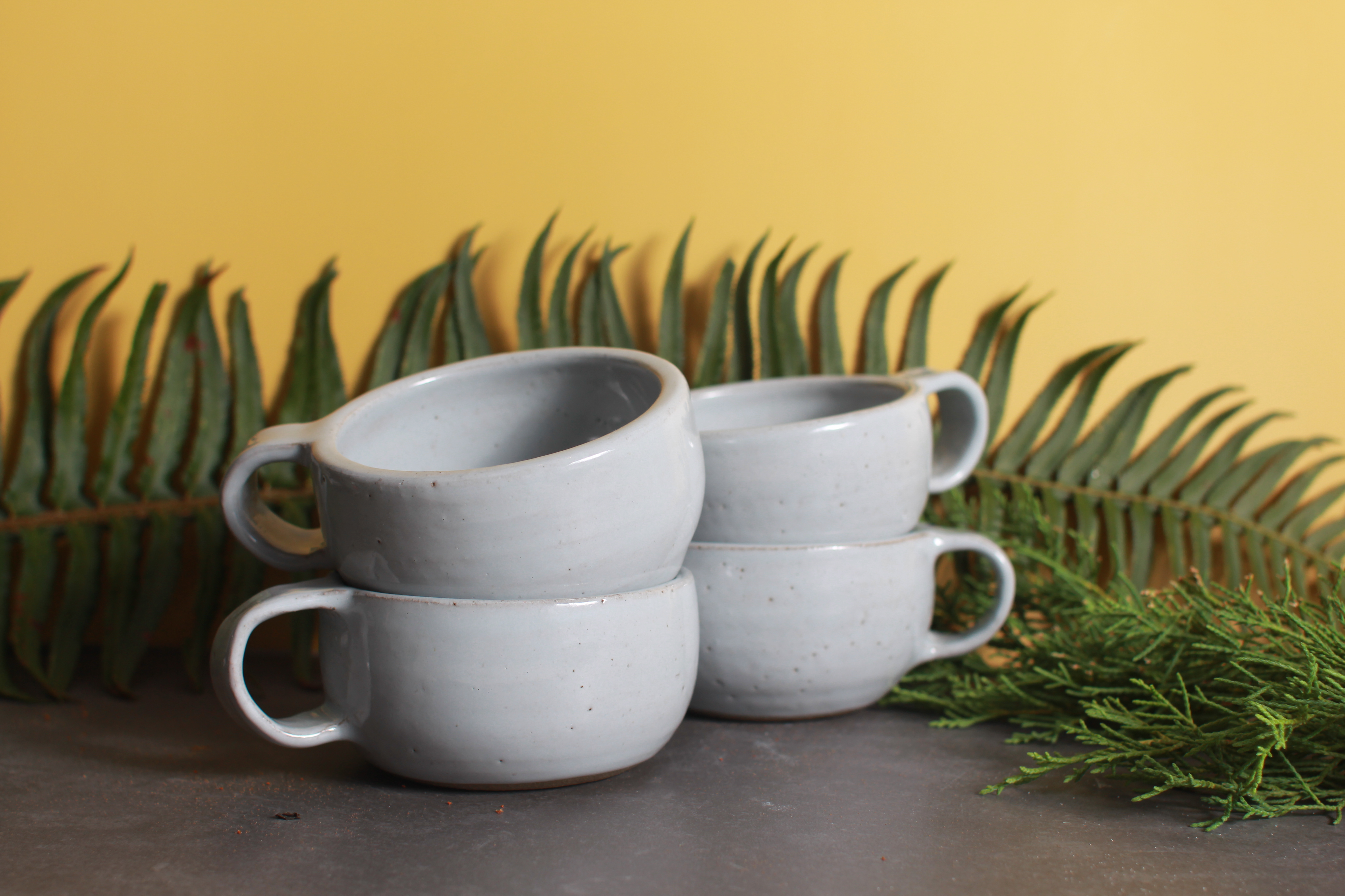 four gray mugs